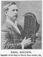 Carl Brown holding Harp-O-Chord